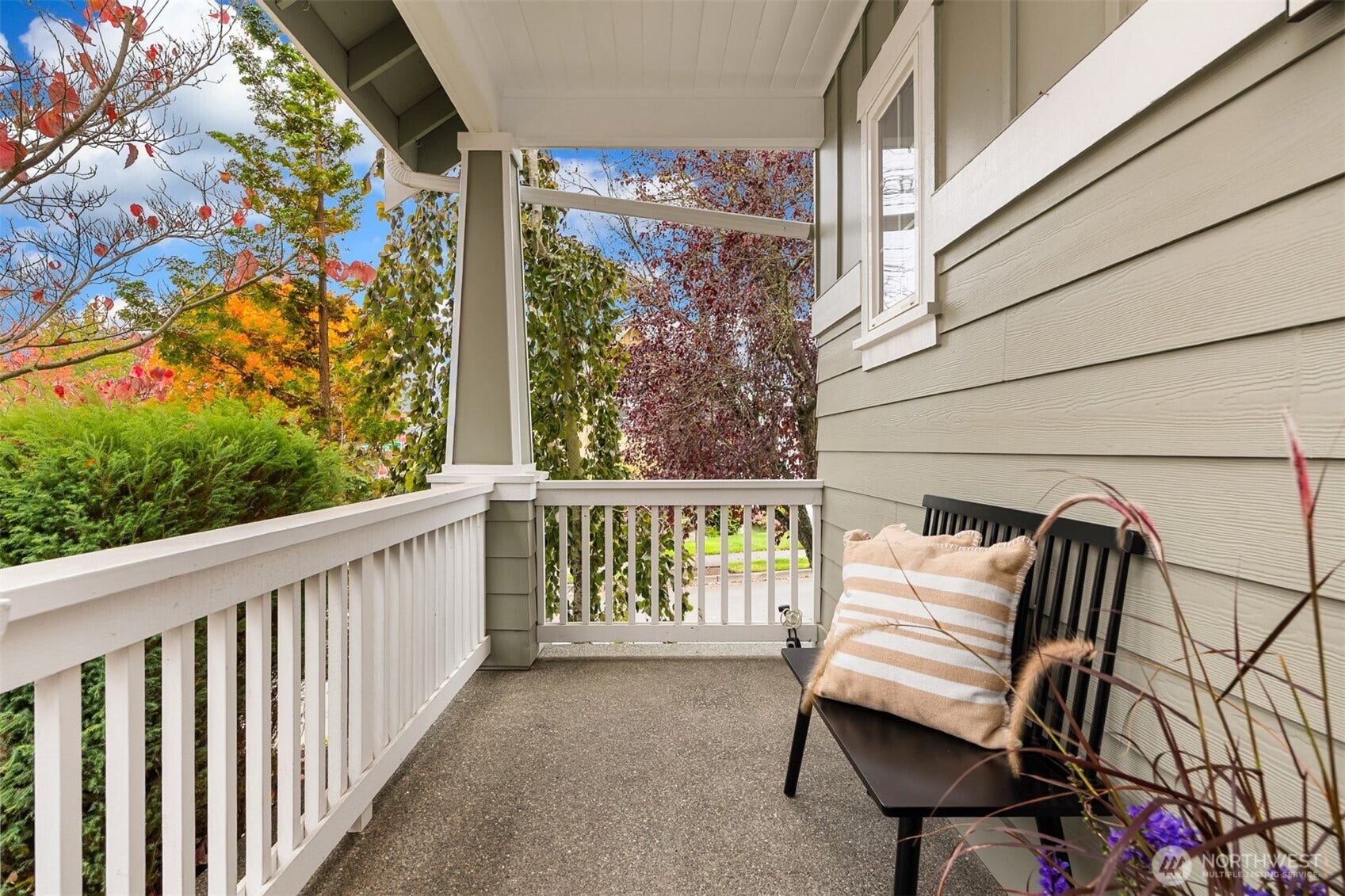 19800 Jensen Way NE, Poulsbo, WA 98370 Start your morning on the covered front porch, a charming spot for coffee overlooking leafy trees and the neighborhood beyond.