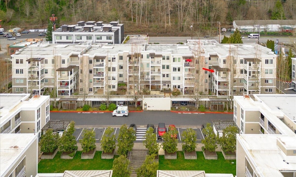 17426 Bothell Way NE, #A302, Bothell, WA 98011 Front Side Of Condo and River across the cross-walk down the steps along the grassy area.