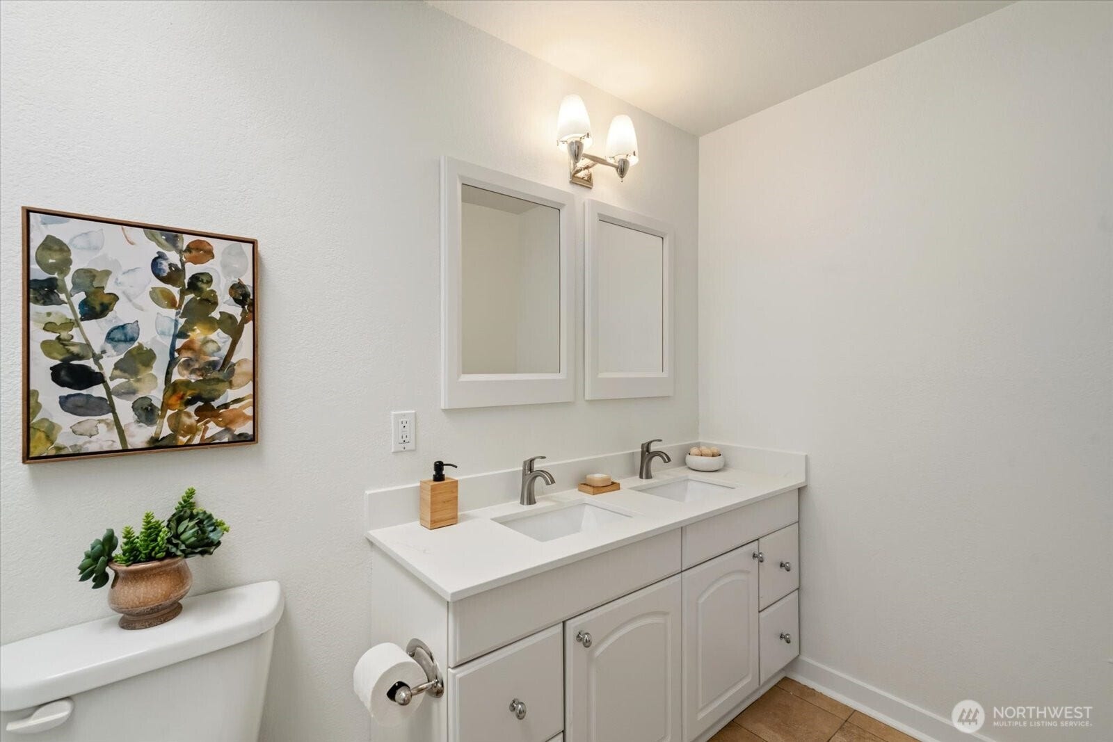 11411 102nd Court NE, Kirkland, WA 98033 The full bath features a double vanity with new counters, sinks, and fixtures.