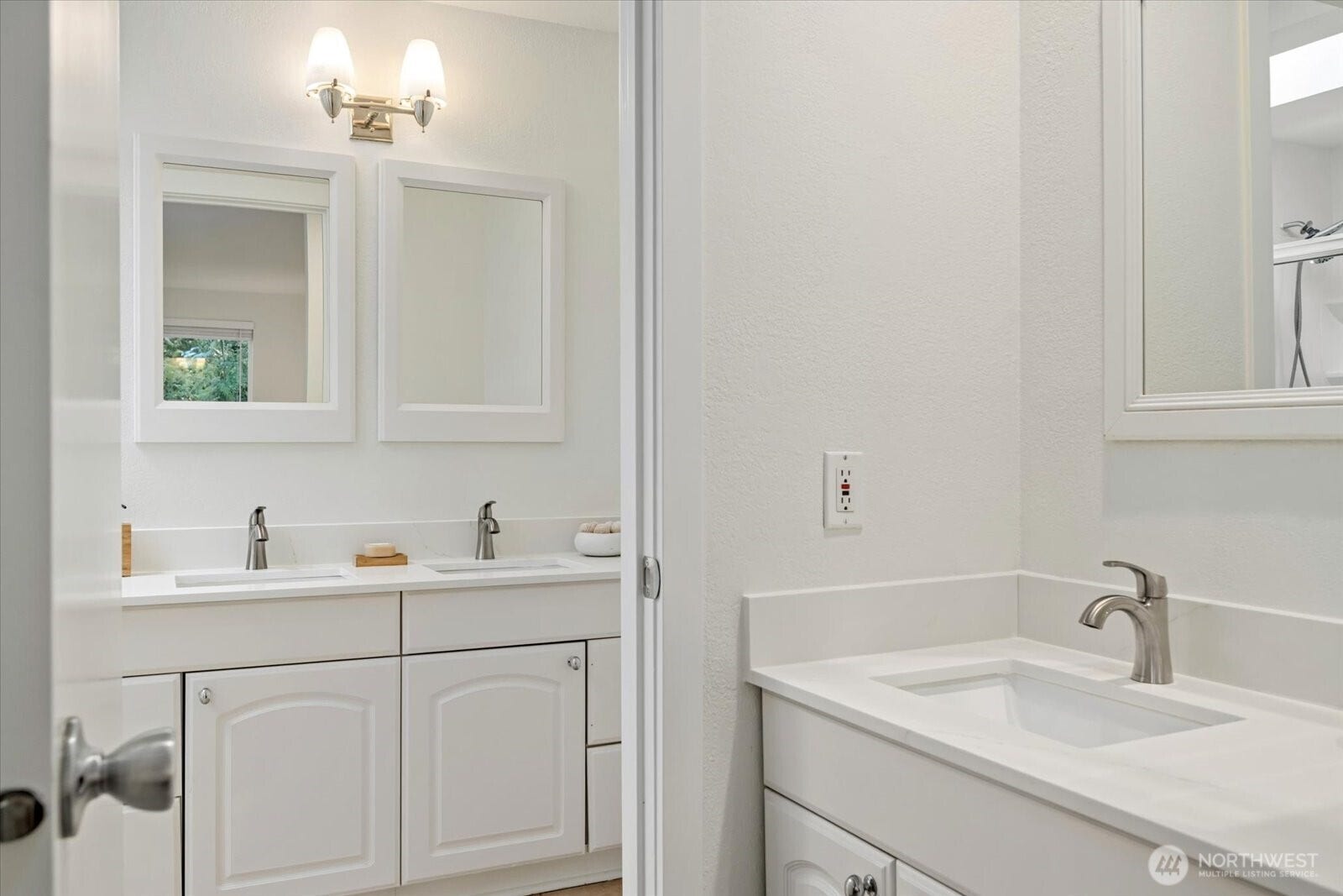 11411 102nd Court NE, Kirkland, WA 98033 Updated counters, sinks, and fixtures bring a fresh, cohesive feel across both vanity areas.