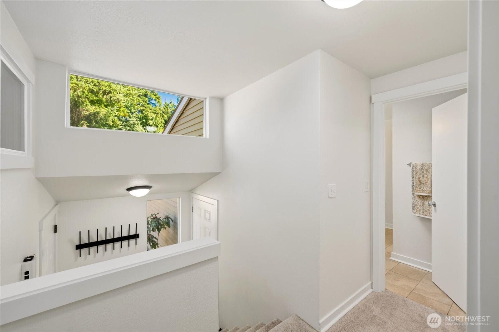 11411 102nd Court NE, Kirkland, WA 98033 Soaring vaulted ceilings, expansive windows, and skylights fill the home with abundant natural light.
