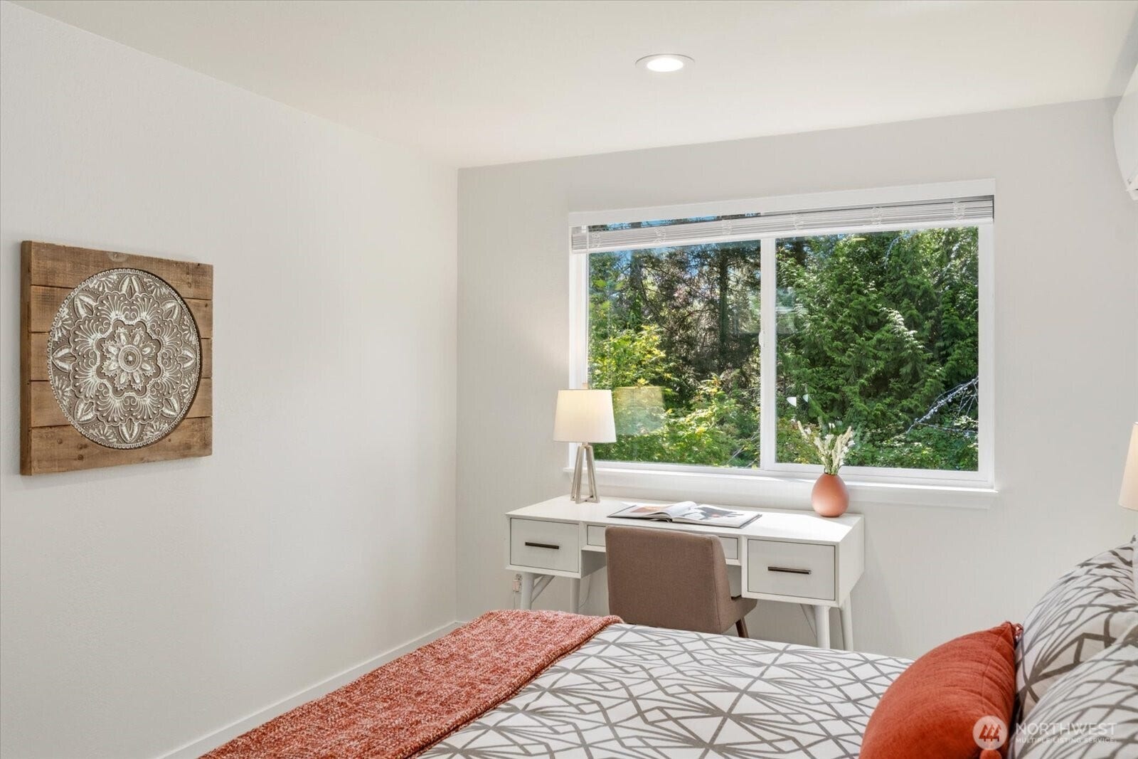 11411 102nd Court NE, Kirkland, WA 98033 Large windows overlook green, tree-filled surroundings, bringing the outdoors in.