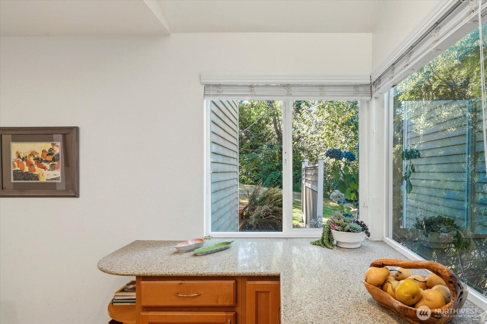 11411 102nd Court NE, Kirkland, WA 98033 Expansive windows frame peaceful green views right from the kitchen counter.