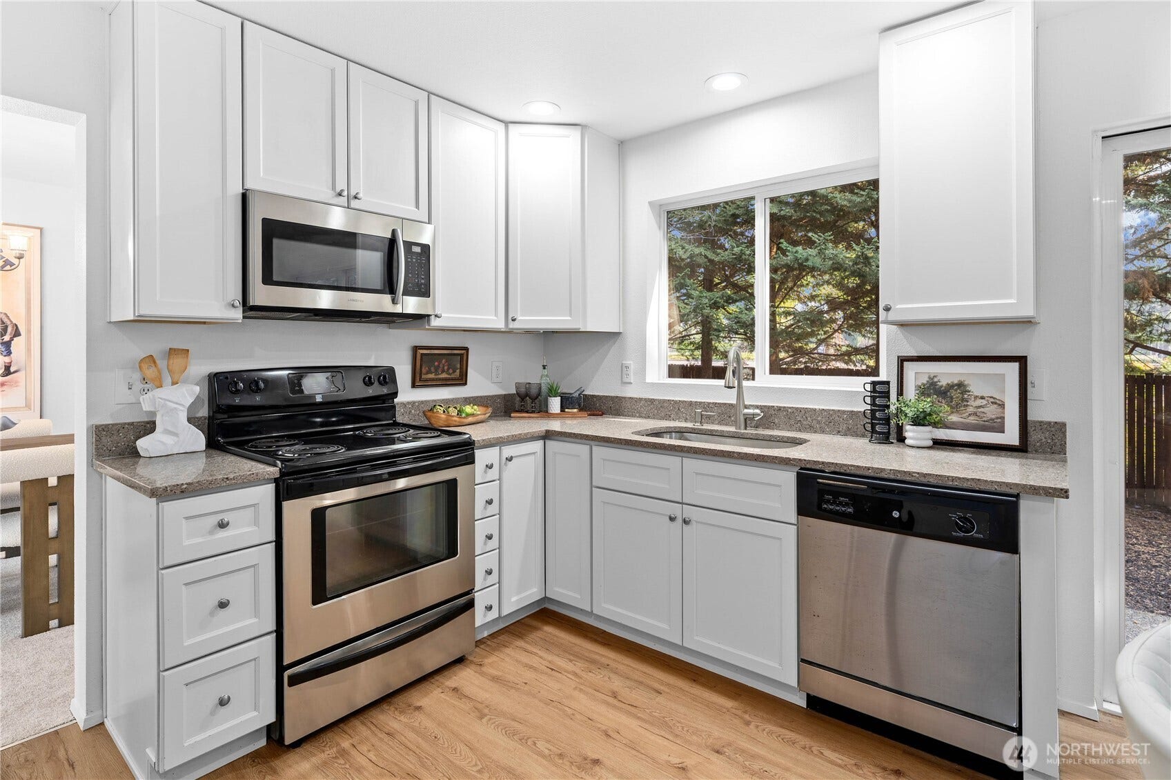 Stainless steel appliance package including a built-in microwave. Enjoy looking into the back gardens while at the sink!