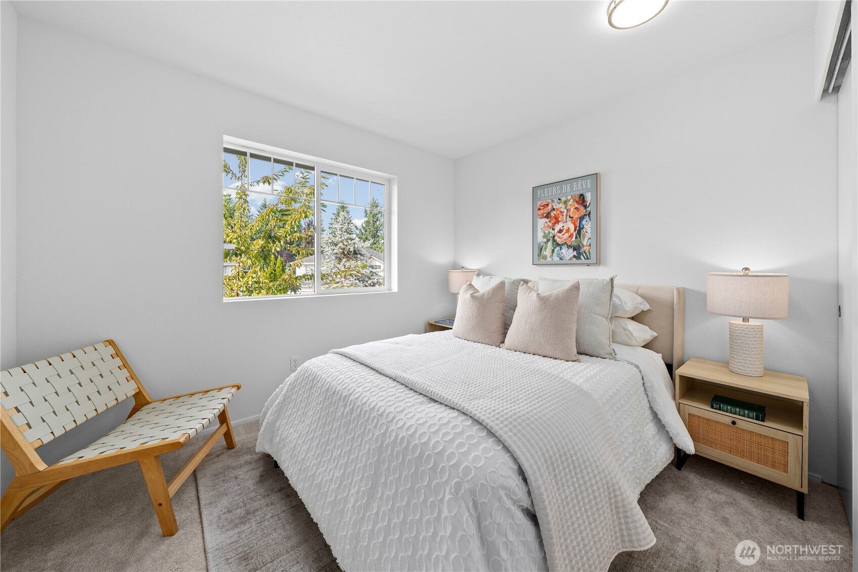 All bedrooms are upstairs, nestled together! Bedroom Two (shown here) features fresh neutral finishes, new carpet, and a generous window that brings in plenty of natural light. Ample space for furnishings and a nicely   sized closet make this room comfortable and functional.