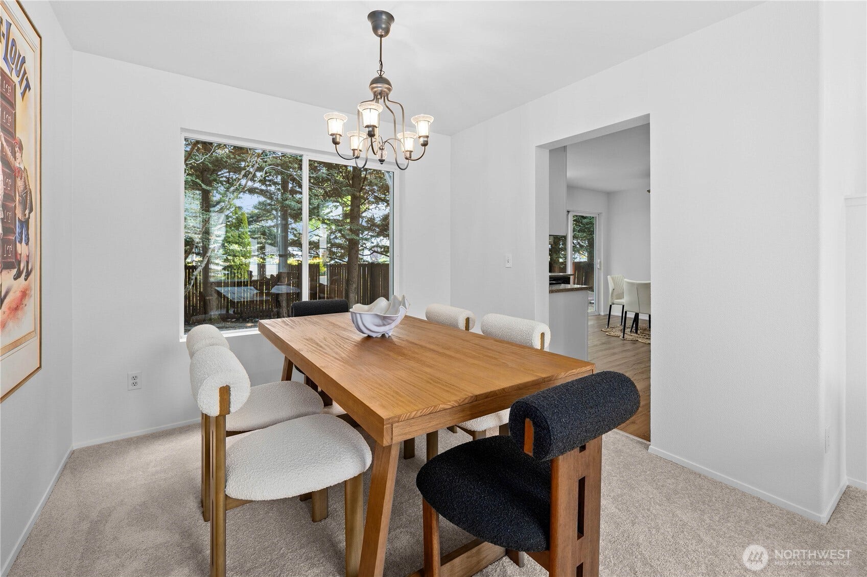 The dining room features a timeless chandelier that matches the entrance's grand chandelier. This room also looks out into the private back yard.