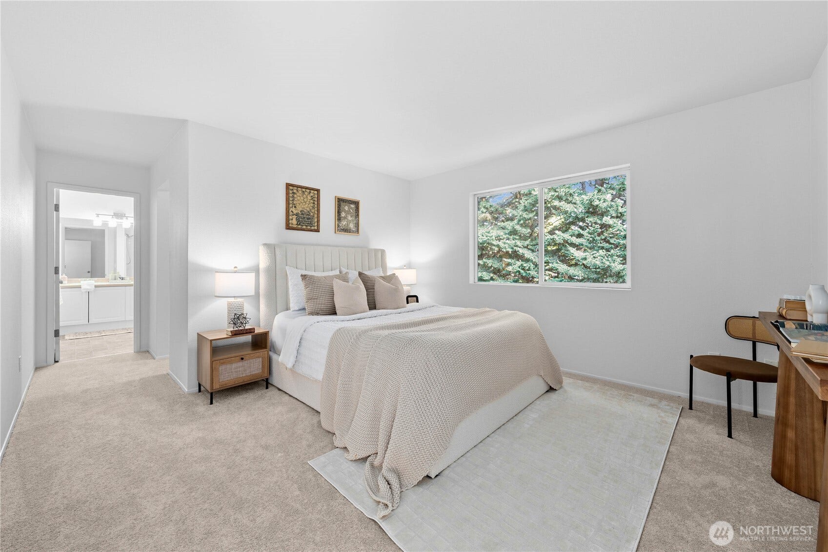The spacious Primary Suite offers a peaceful retreat with fresh neutral finishes, new carpet, and a large window framing views of the mature trees in the back yard. A private bath and walk-in closet complete the suite   with added comfort and functionality.