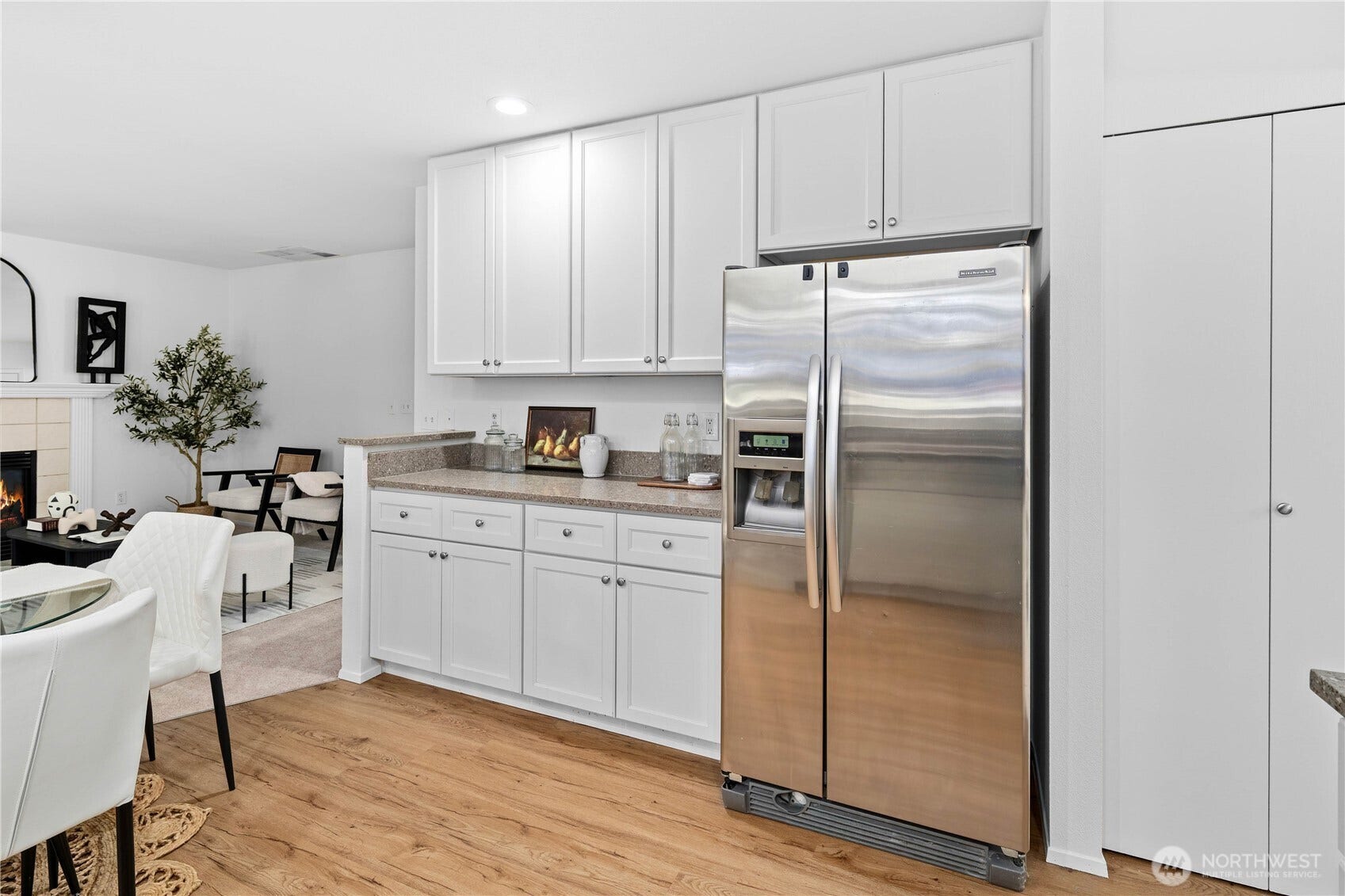 You'll find a pantry behind the bi-fold doors, providing lots of storage space! Also lots of counter space next to the stainless refrigerator with built-in water dispenser!