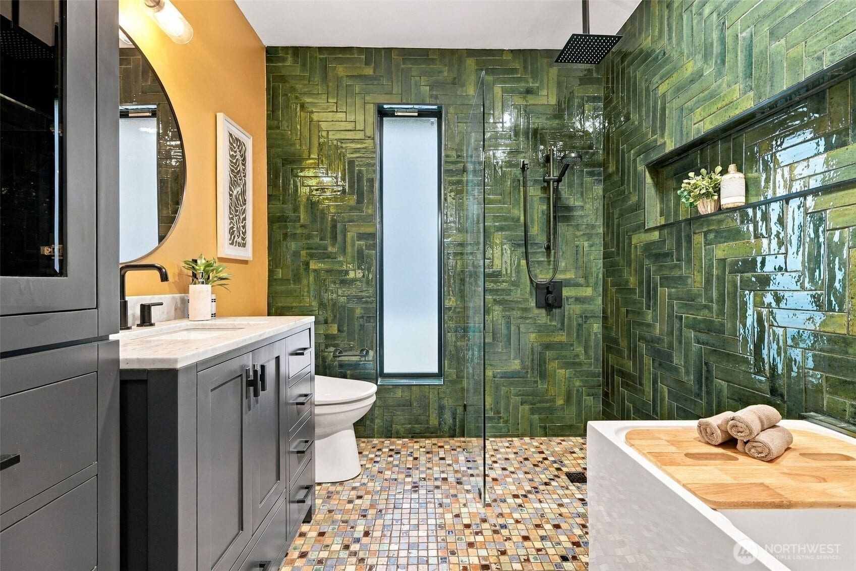 Main floor full bathroom with walk-in rain shower, Japanese soaking tub, and waterfall faucet.