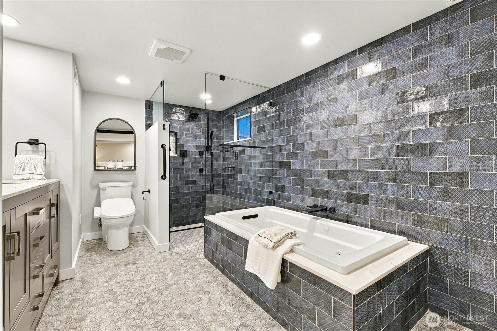 Spa-like full bath with walk in shower and jetted tub.