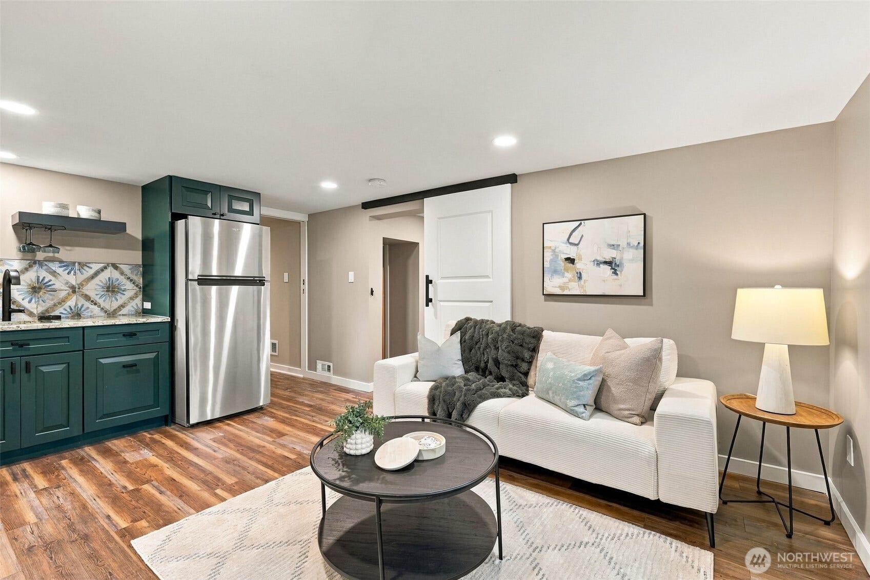 Downstairs primary suite or MIL with sitting room and beautifully finished kitchenette. Great ceiling height throughout lower level.