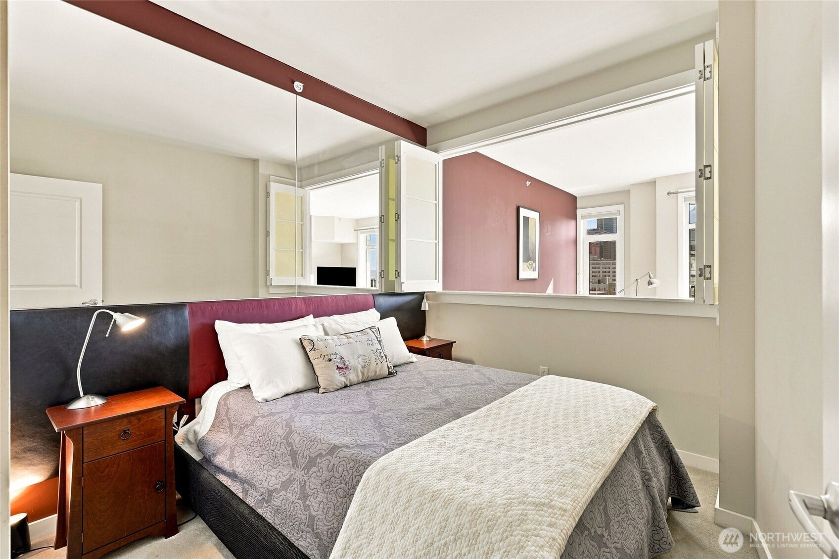 2607 Western Avenue, #1002, Seattle, WA 98121 Versatile bedroom with elegant folding privacy walls, offering the flexibility of an open-concept feel or private sleeping quarters.