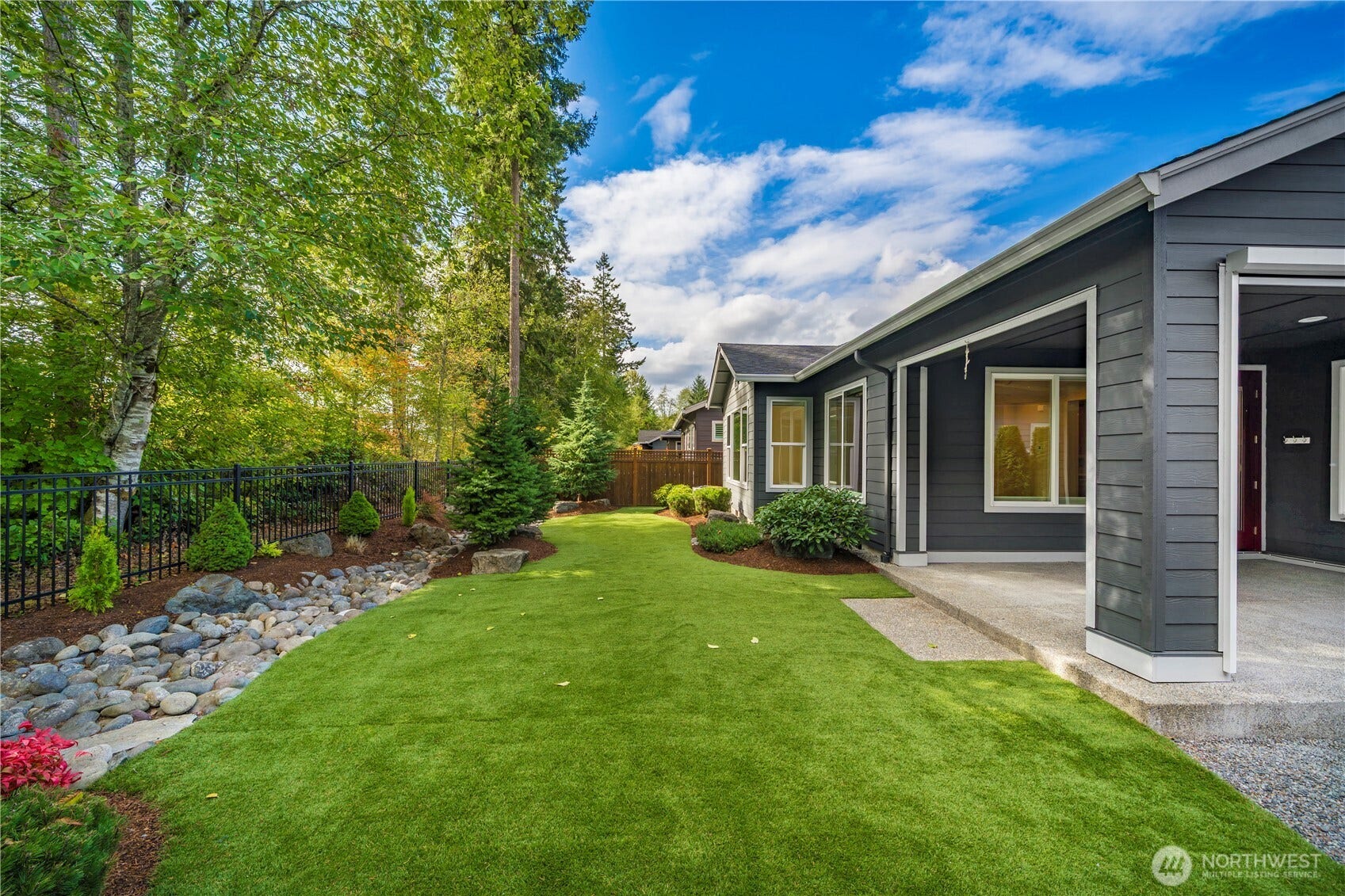 19014 146th Street E, Bonney Lake, WA 98391 The oversized covered patio (with a motorized sun/privacy screen) spills out into this amazing yard.