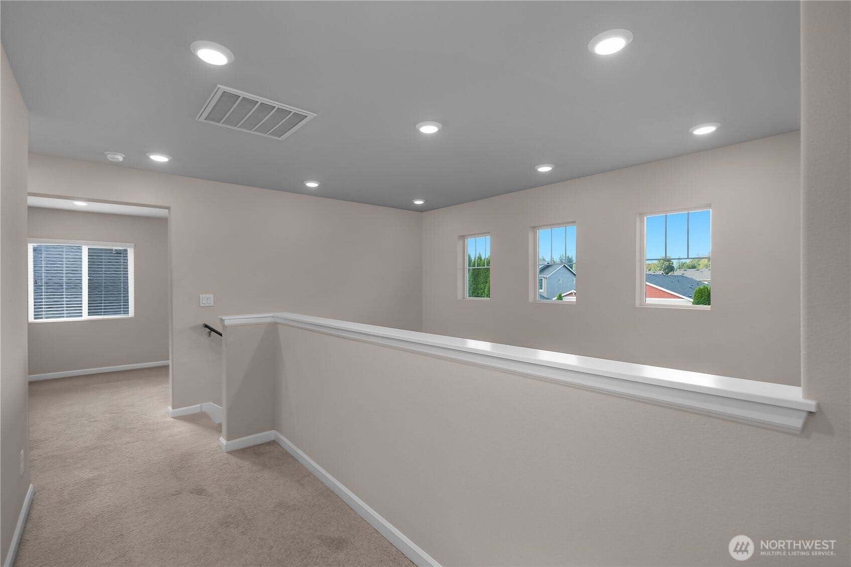 7040 Desperado Drive SE, Tumwater, WA 98501 Different angle of the upstairs hallway. Open area leads to Den/office and utility room. Straight in front of the stairs leads to the primary bedroom.