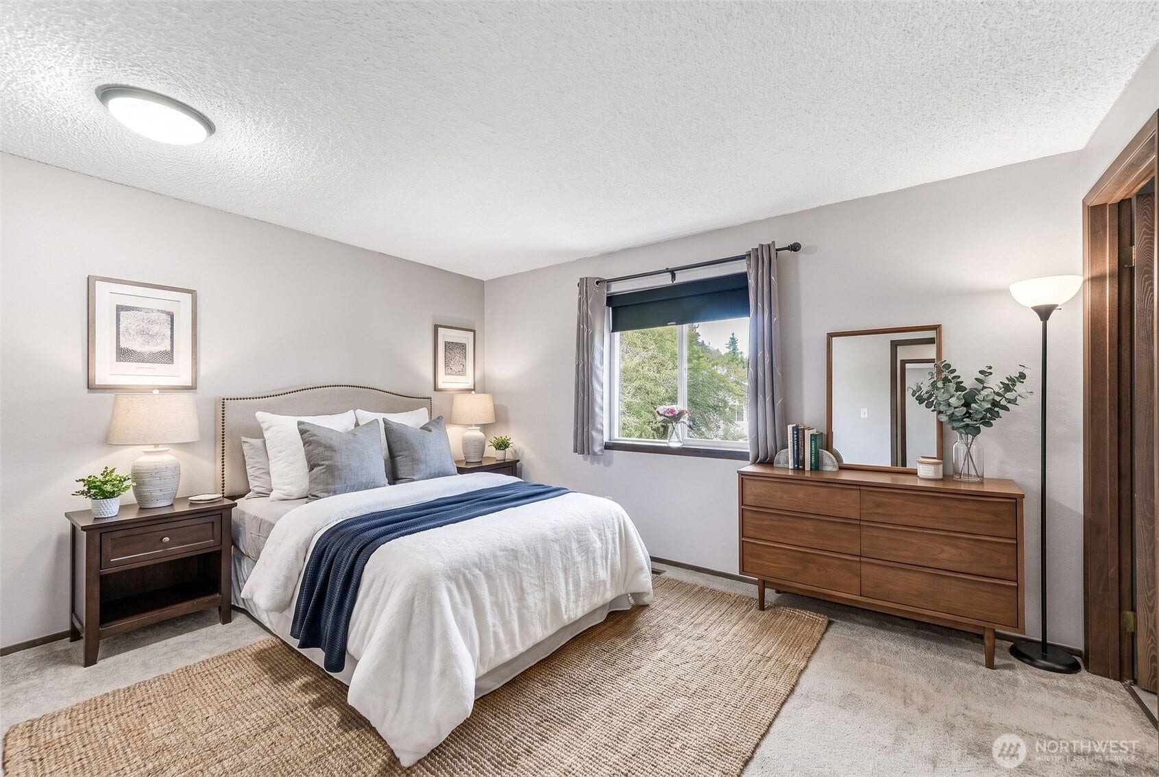 Primary bedroom with en suite and walk-in closet. Backyard views. Virtually staged.
