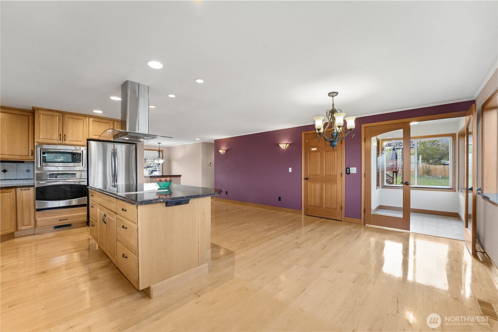 Sunroom with custom elevator on the left of French doors.