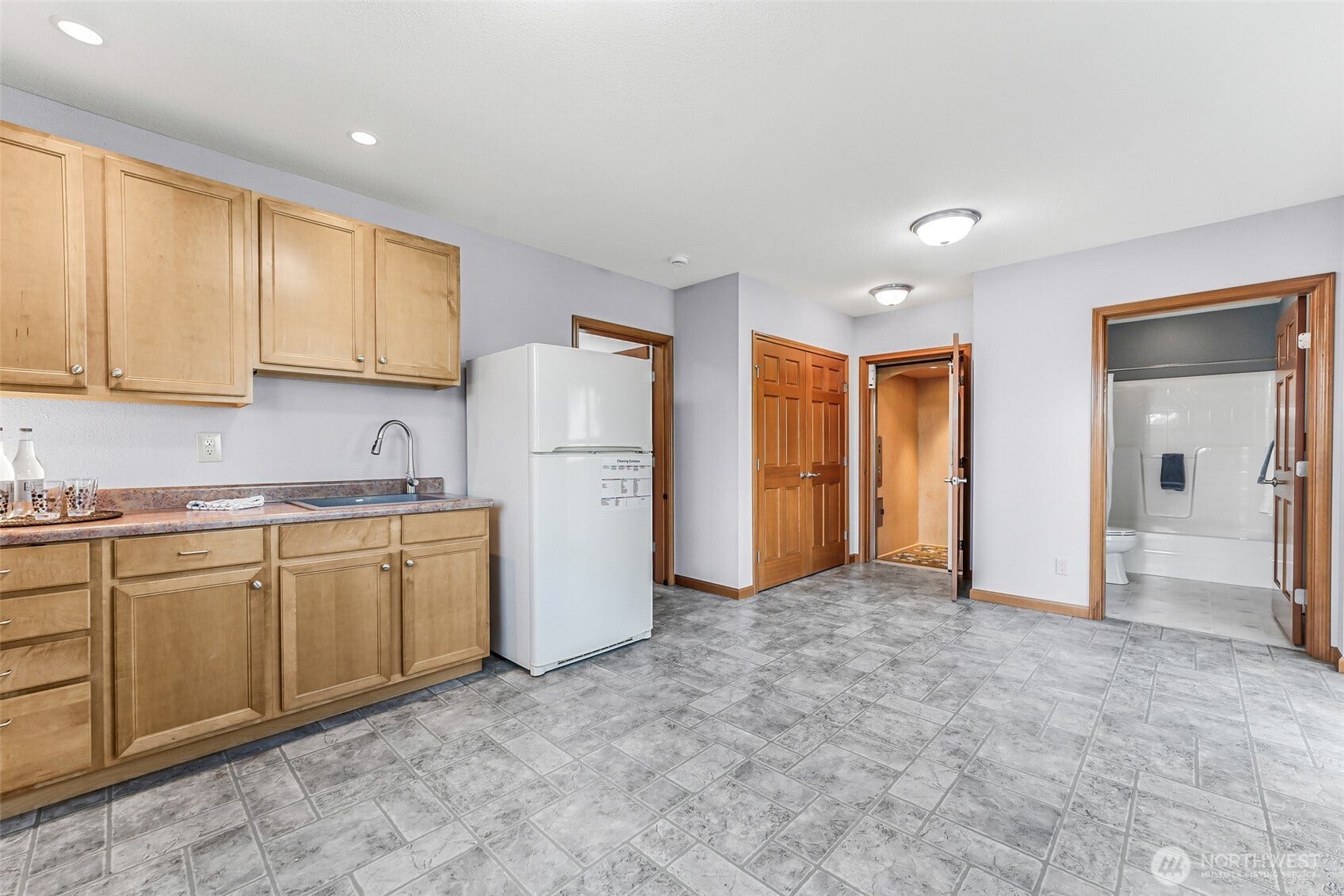 Kitchen area. Shows elevator access from the lower level.