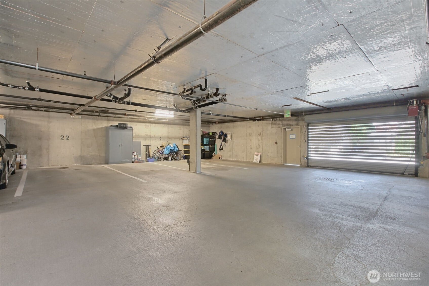 Enter the secured parking garage from SW Alaska St