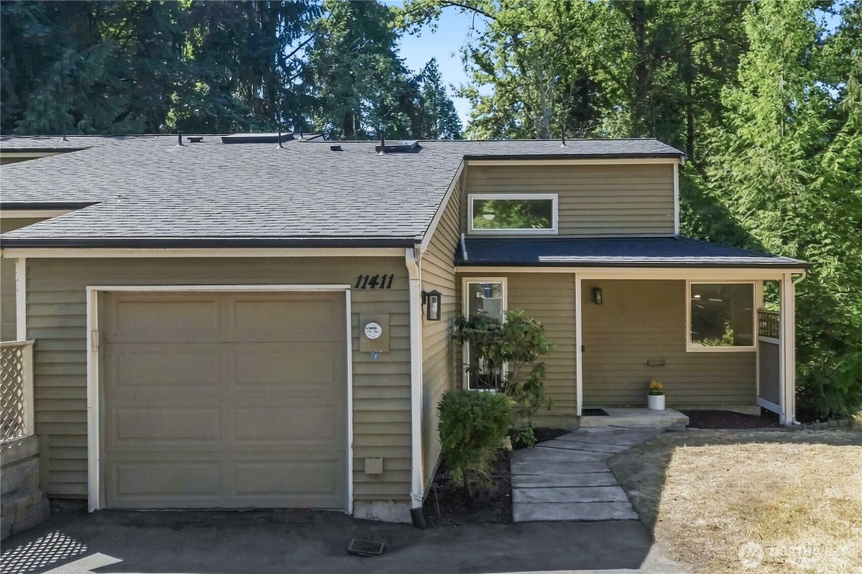 11411 102nd Court NE, Kirkland, WA 98033 Attached one-car garage with EV charging offers direct home access, plus guest parking nearby.