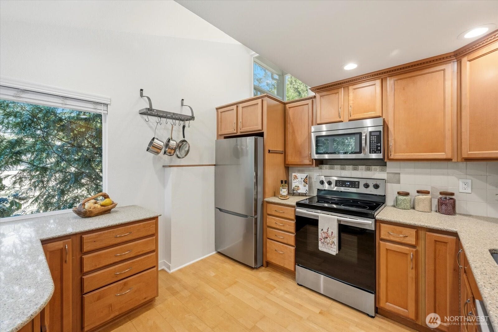 11411 102nd Court NE, Kirkland, WA 98033 Soaring vaulted ceilings and expansive windows fill the space with abundant natural light.