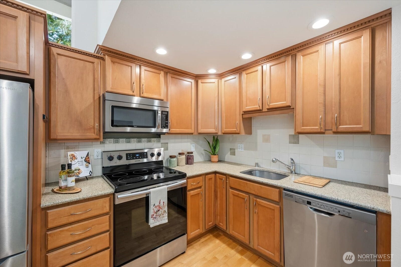 11411 102nd Court NE, Kirkland, WA 98033 Abundant cabinetry and generous counter space support everyday cooking and entertaining.