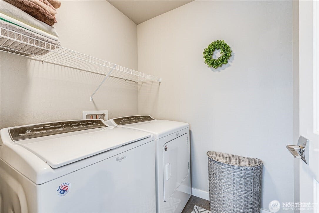 Laundry room with full size washer and dryer.