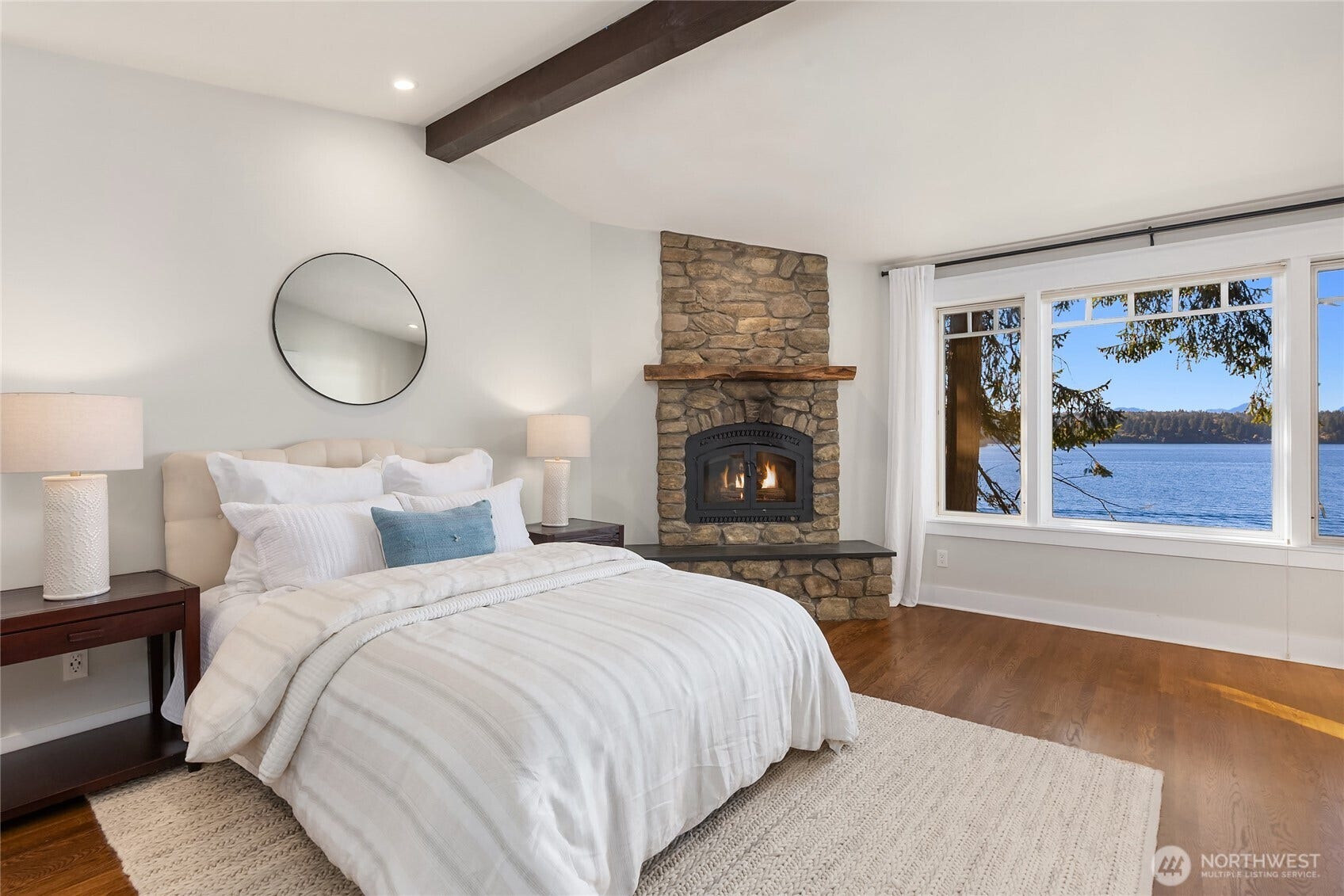 8405 Hansen Road NE, Bainbridge Island, WA 98110 The primary bedroom with wood burning fireplace.
