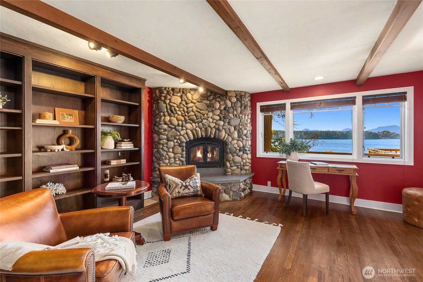 8405 Hansen Road NE, Bainbridge Island, WA 98110 The library with wood burning fireplace and built-in cabinetry and shelving.