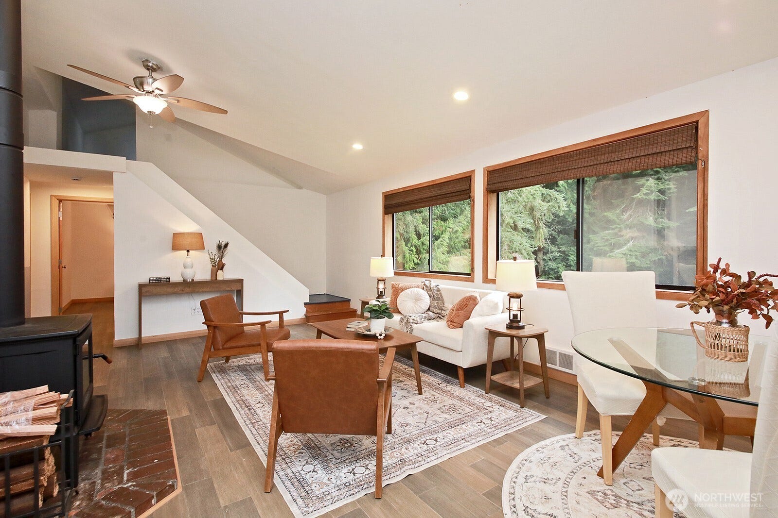 You can see the open staircase that leads to the loft area. You need to duck your head to enter the loft, however, most will be able to fully stand once you have stepped inside. Hallway to bedrooms and bath can be seen along left edge of photo.