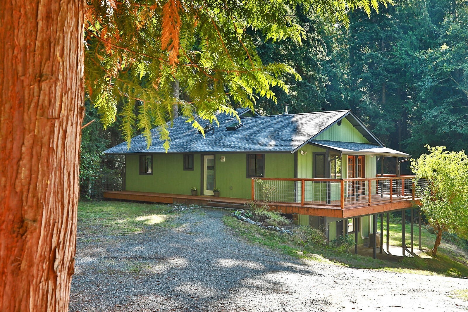 Welcome to 2959 Foxfire Lane, privately perched in the sunshine on a double lot surrounded by lush forested land. Brand new roof (August 2026). Come see all the remodeling that has been completed. Glass door with white border is the main entrance.