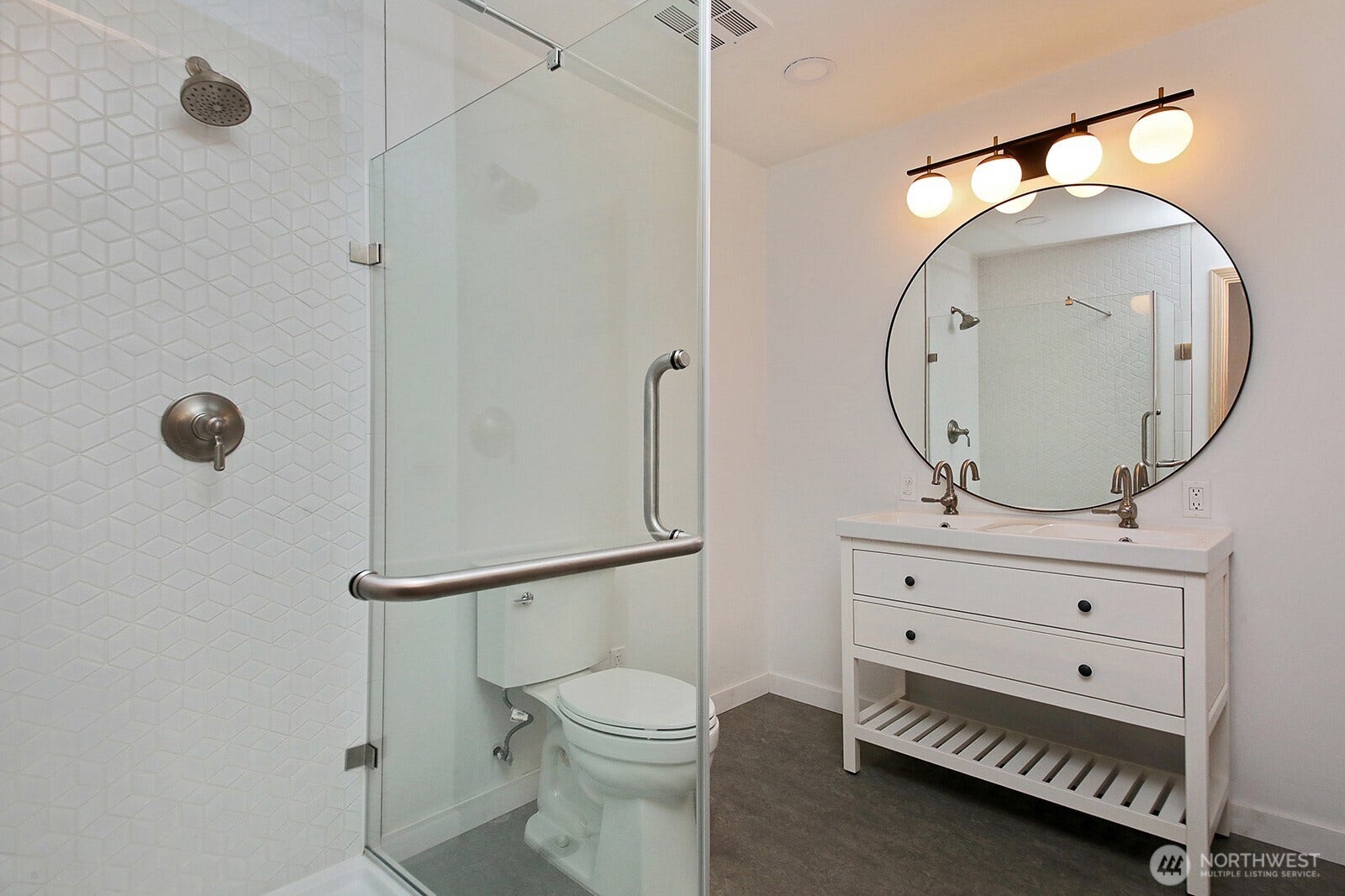 Remodeled Primary bathroom with double sink and spacious shower. Floors are marmoleum.