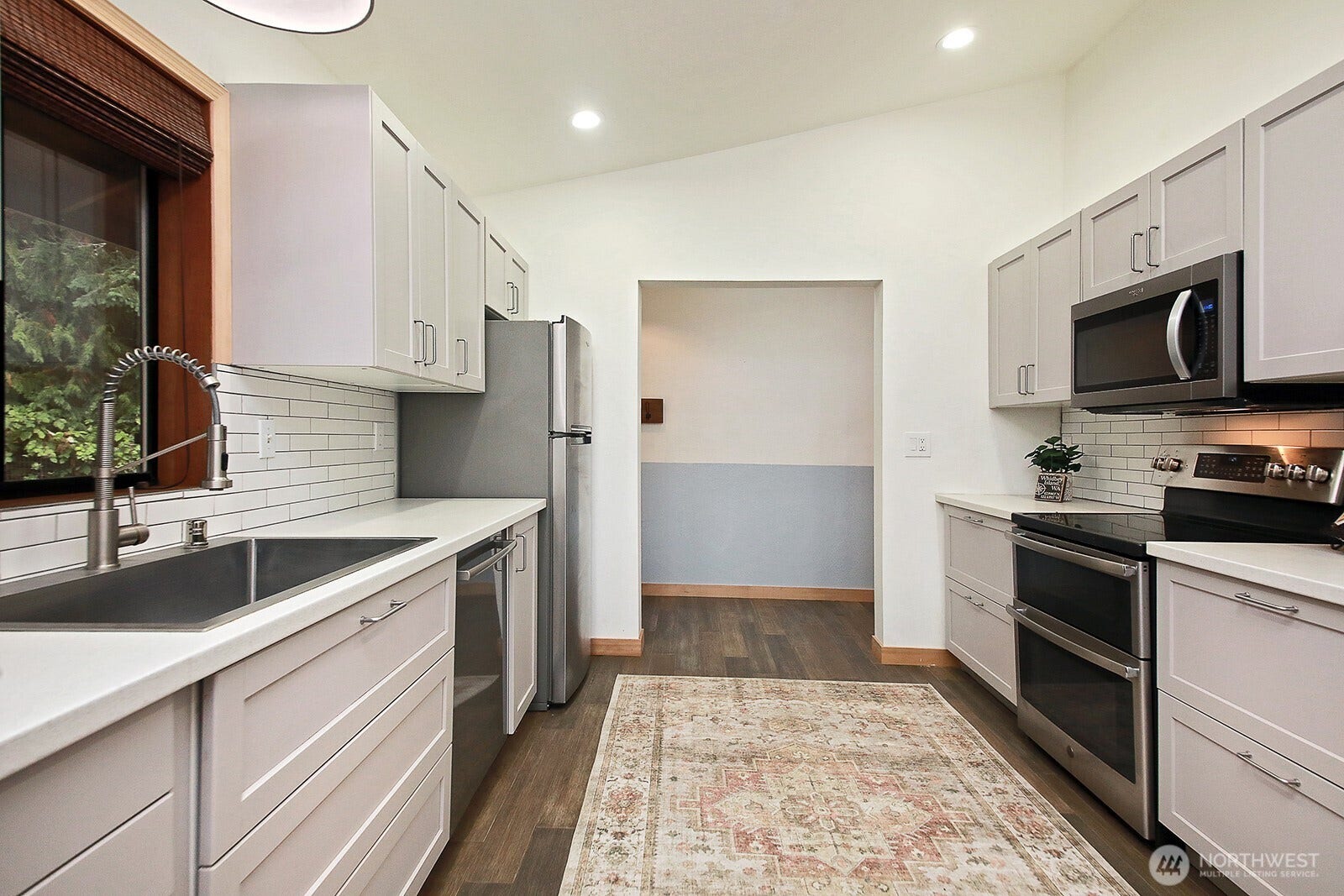 Kitchen has been reconfigured during seller's ownership.  Previously there was a wall with a speakeasy straight ahead.