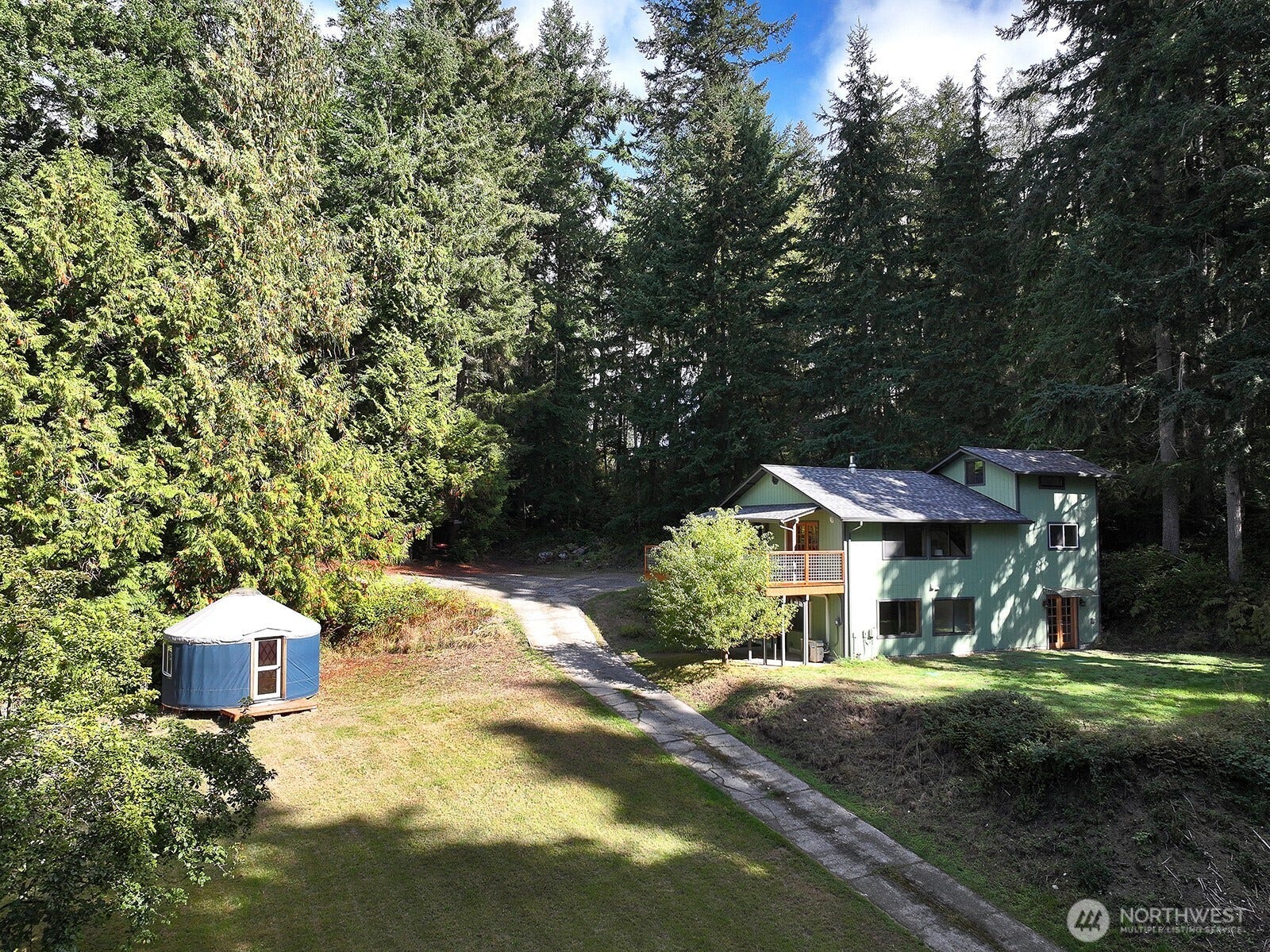 A wider perspective of the double lot. 200 sq ft yurt conveys with a full priced offer and is otherwise negotiable.