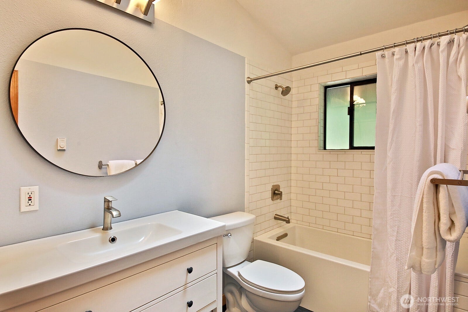 Main level remodeled full bath with slate floors. There is a cabinet to the left of the sink (not in this photo).