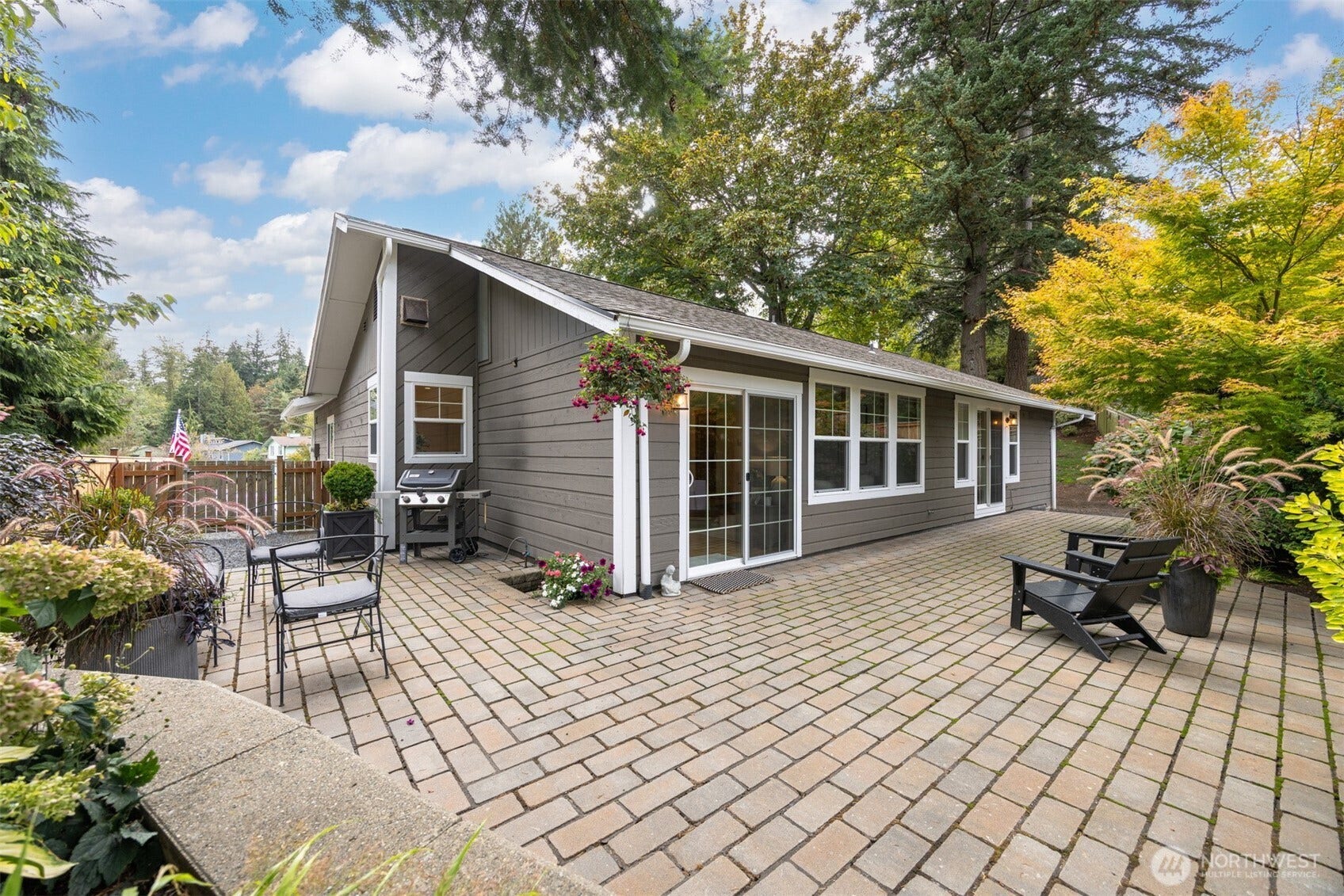 3793 Greenville Place, Bellingham, WA 98226 Looking across the spacious and fully fenced rear yard with a large patio surrounded by lush and mature landscape.