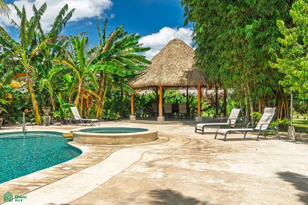La Iguana Dorada Fully Furnished Condo - Near Playa Grande, Playa Grande, Cabo Velas, Santa Cruz, Guanacaste, Costa Rica 50309 Additional pool view with tropical surroundings and a shaded community rancho.