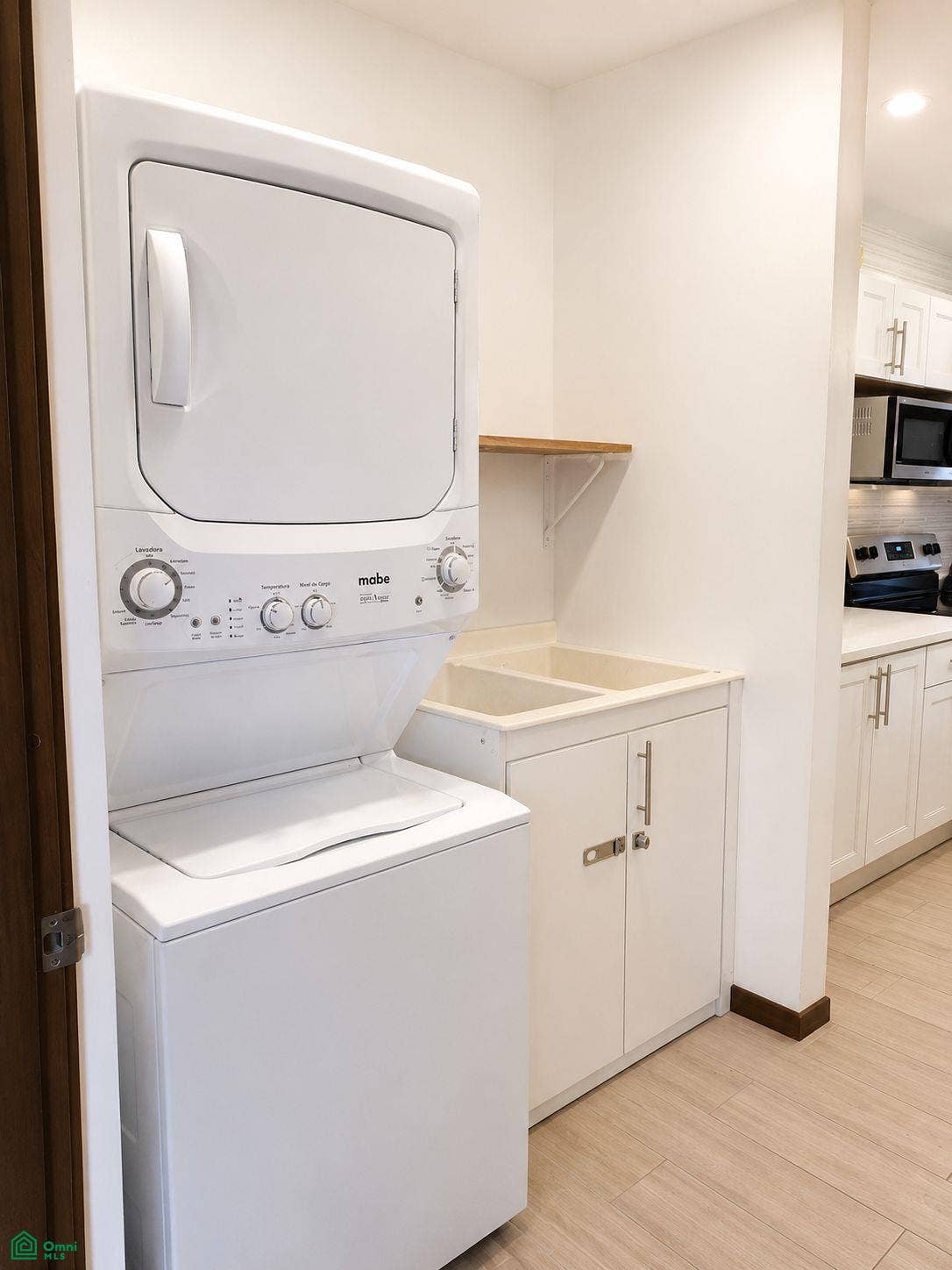 La Iguana Dorada Fully Furnished Condo - Near Playa Grande, Playa Grande, Cabo Velas, Santa Cruz, Guanacaste, Costa Rica 50309 Stacked washer and dryer with an adjacent utility sink and storage.