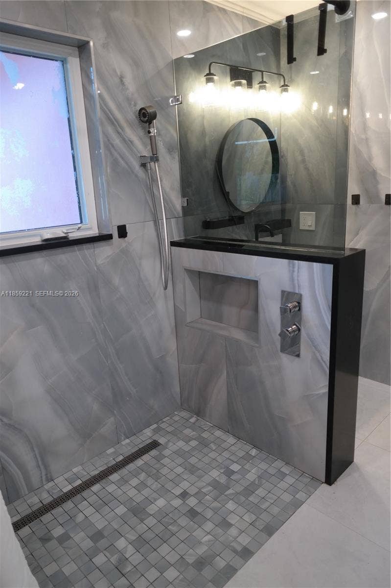 524 NE 27th Drive, Wilton Manors, FL 33334 Functional bathroom enhancements deliver a spa-like experience with easy-access features designed for comfort and relaxation