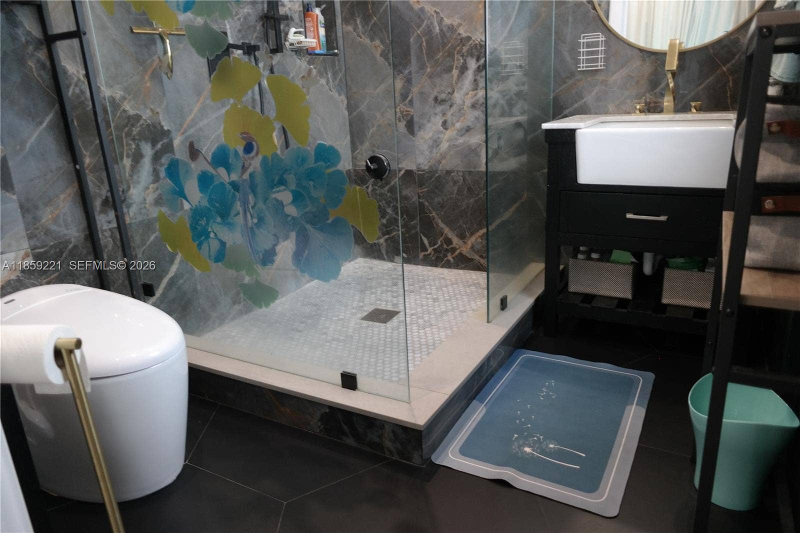524 NE 27th Drive, Wilton Manors, FL 33334 Beautiful and functional private bathroom featuring a smart toilet, a spacious, easy-access walk-in shower and stylish deep ceramic sink with exposed front, for a luxurious experience.