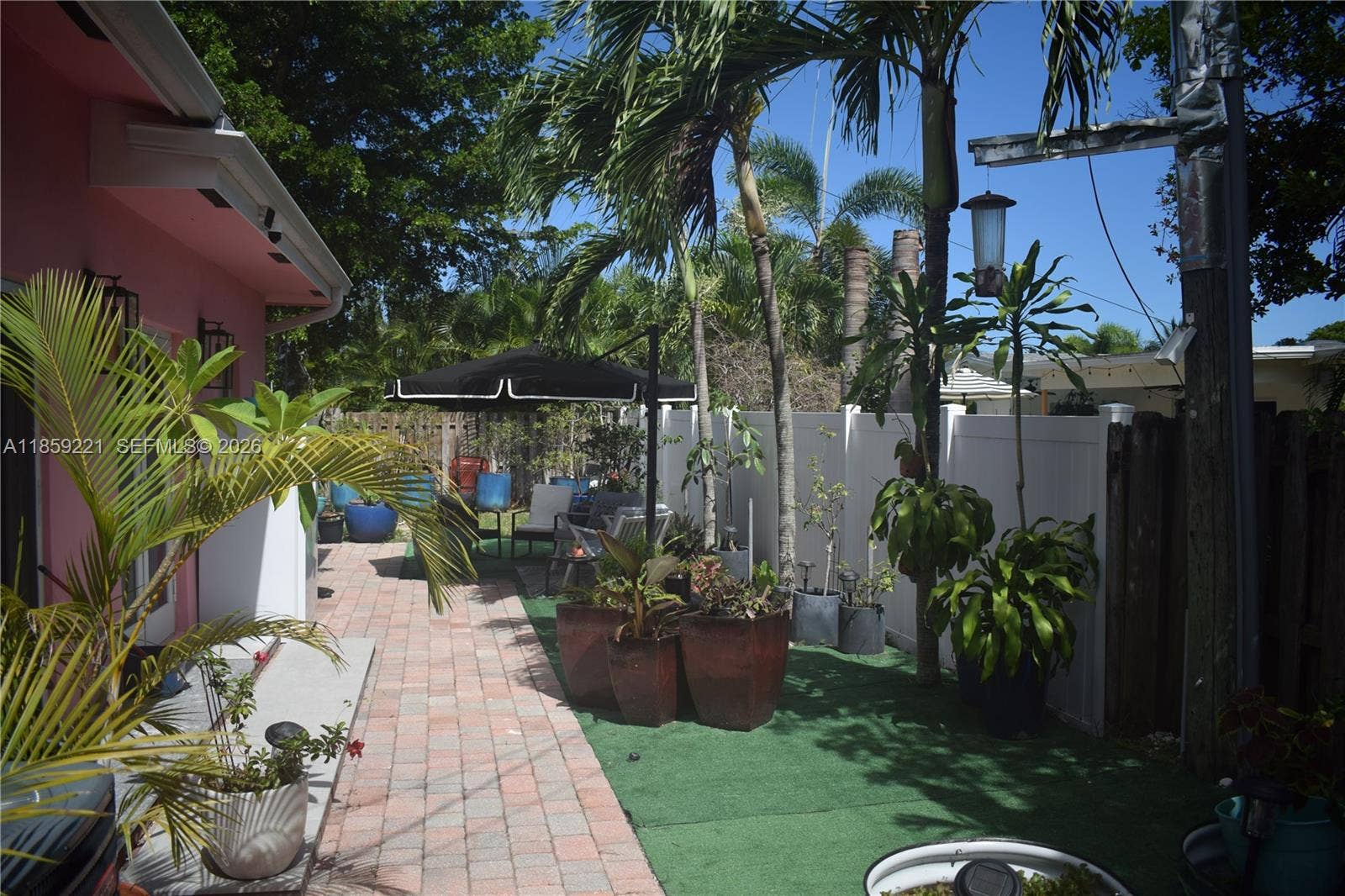 524 NE 27th Drive, Wilton Manors, FL 33334 Lush garden setting with a variety of plants and thoughtfully designed zones for outdoor enjoyment