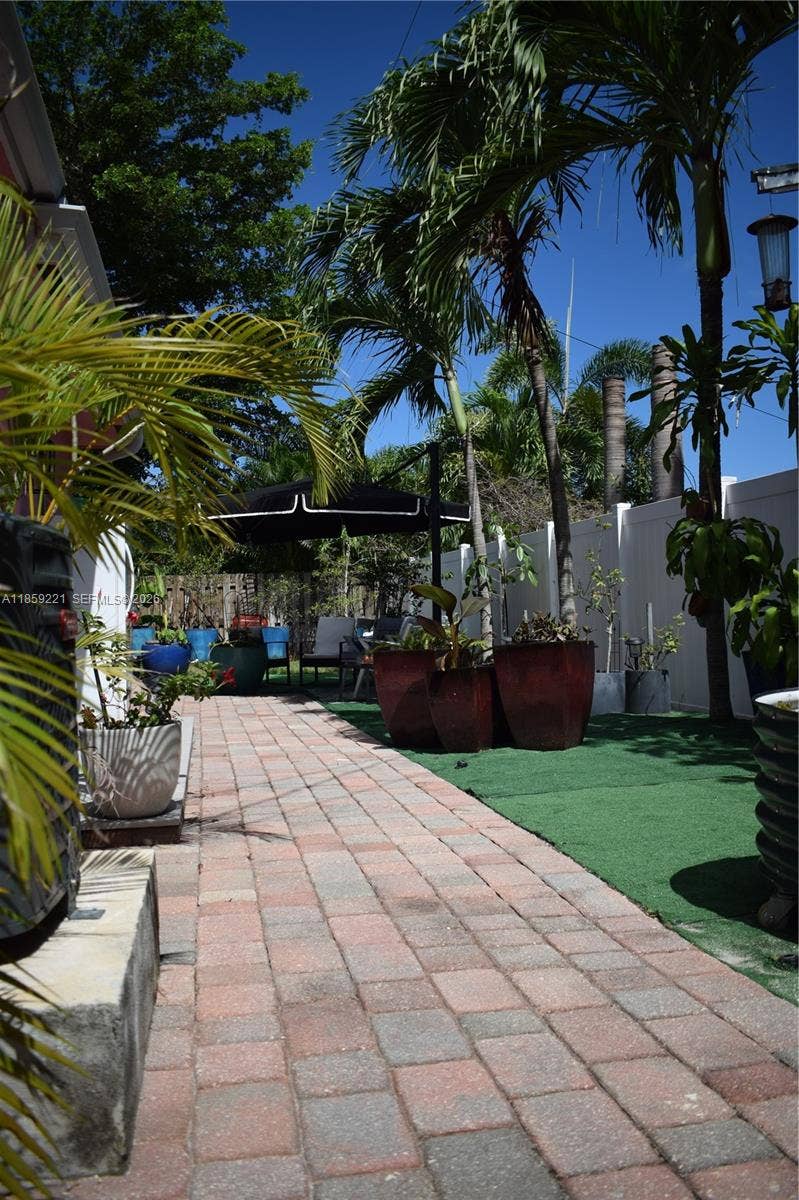 524 NE 27th Drive, Wilton Manors, FL 33334 Backyard features diverse landscaping and multiple areas for relaxation and entertainment