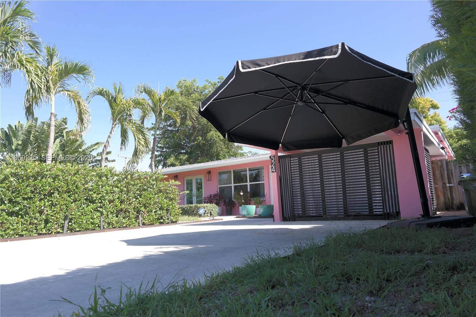 524 NE 27th Drive, Wilton Manors, FL 33334 Expansive front entrance featuring a wide driveway that accommodates four cars with ease.