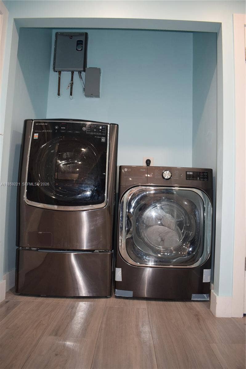 524 NE 27th Drive, Wilton Manors, FL 33334 Modern and functional laundry area paired with a state-of-the-art water heater for everyday comfort and efficiency