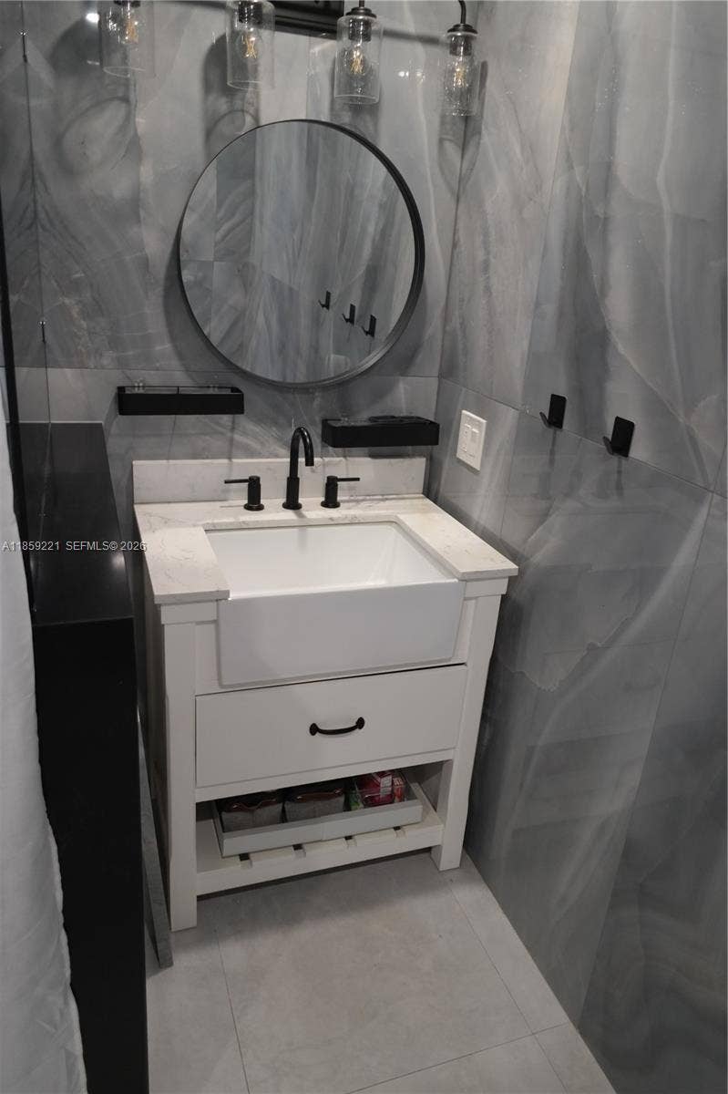524 NE 27th Drive, Wilton Manors, FL 33334 Bathrooms feature beautiful, modern deep sinks that elevate the space with clean lines and stylish finishes.