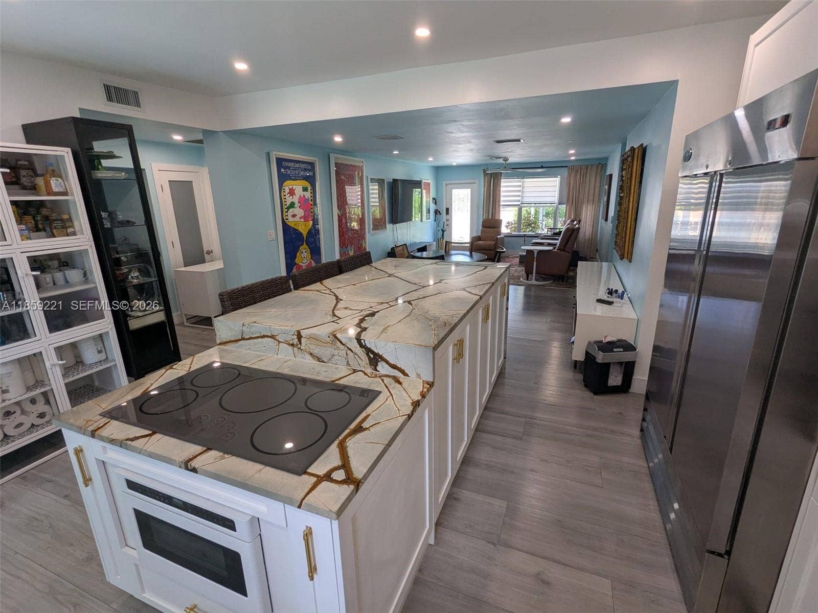 524 NE 27th Drive, Wilton Manors, FL 33334 Gorgeous showstopper island with quartz countertop and sleek lower-level electric range and plenty of storage in a modern kitchen design.