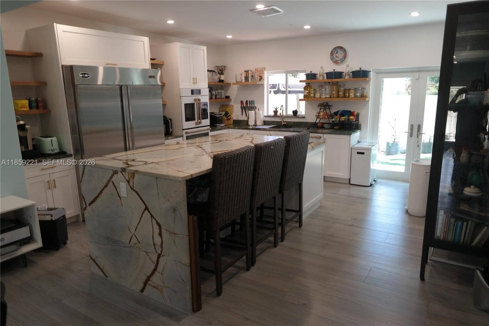 524 NE 27th Drive, Wilton Manors, FL 33334 Beautiful quartz island with waterfall edges and plenty of space for family breakfasts. Notice enough room to tuck chairs neatly underneath.