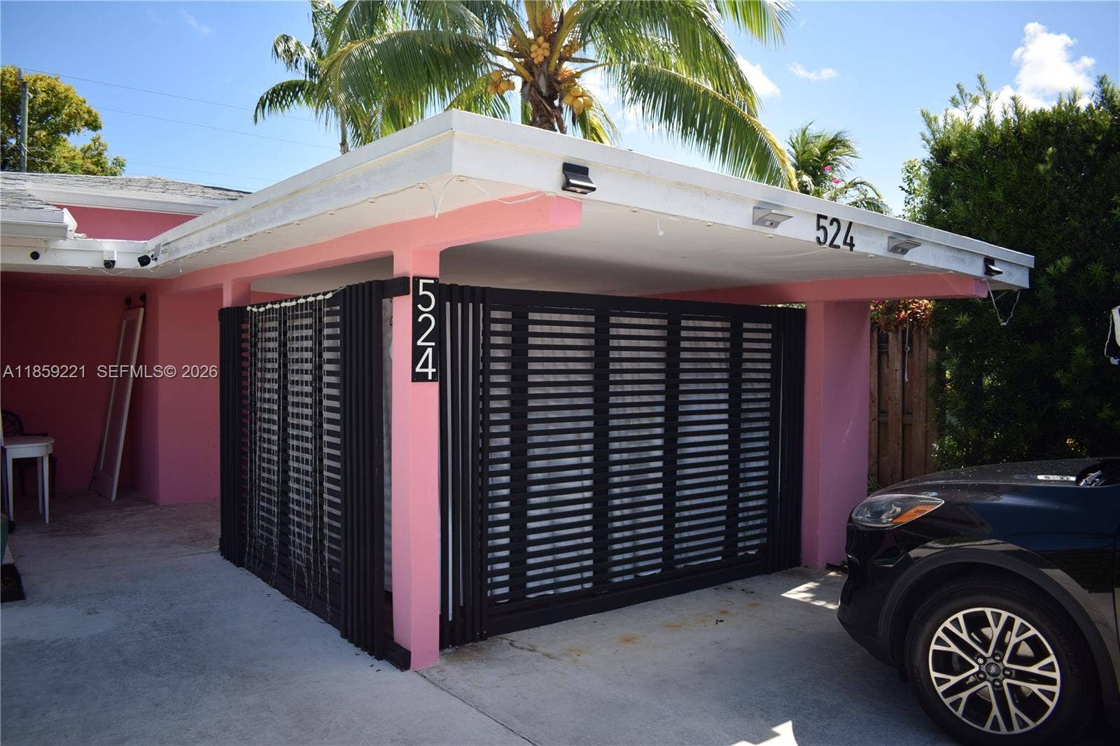 524 NE 27th Drive, Wilton Manors, FL 33334 Adapted covered carport offers extra living space with endless possibilitieswhether as a personal gym, art studio, or custom bar setup
