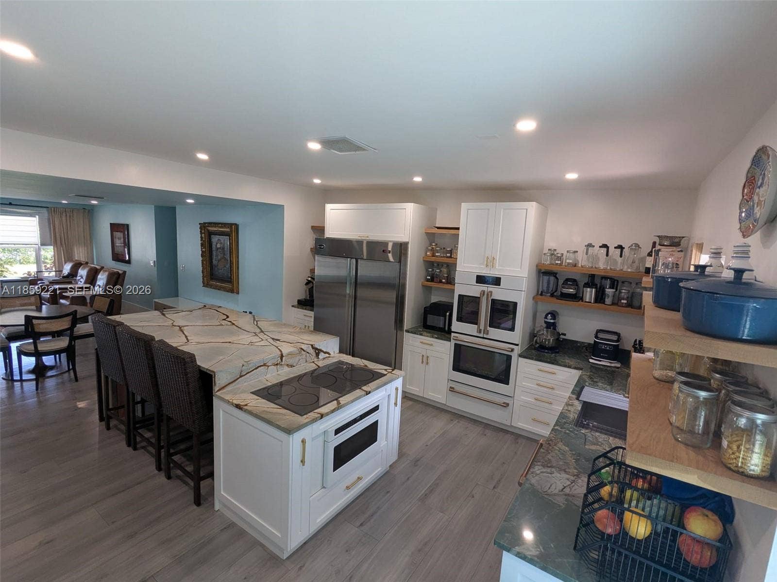 524 NE 27th Drive, Wilton Manors, FL 33334 Luxurious kitchen with high ceiling, accented by designer recessed lighting and appliances matching the cabinetry that complement the space beautifully