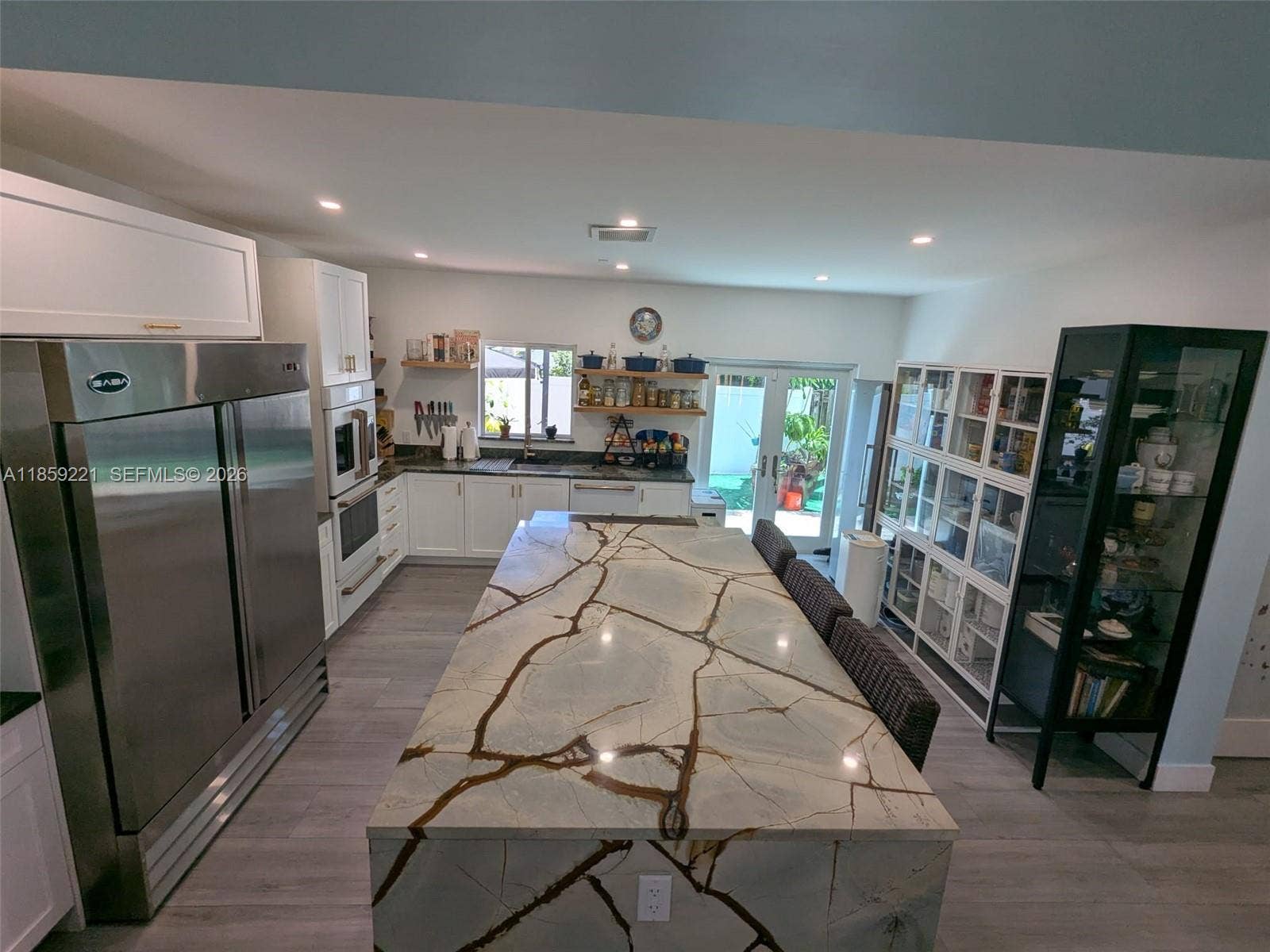 524 NE 27th Drive, Wilton Manors, FL 33334 Striking quartz waterfall island with generous breakfast seating, perfect for elegant mornings