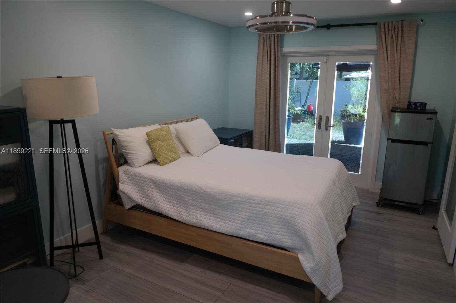 524 NE 27th Drive, Wilton Manors, FL 33334 Oversized room with abundant space, enhanced by dual ceiling fans and French doors that connect indoor comfort with outdoor charmfront and back